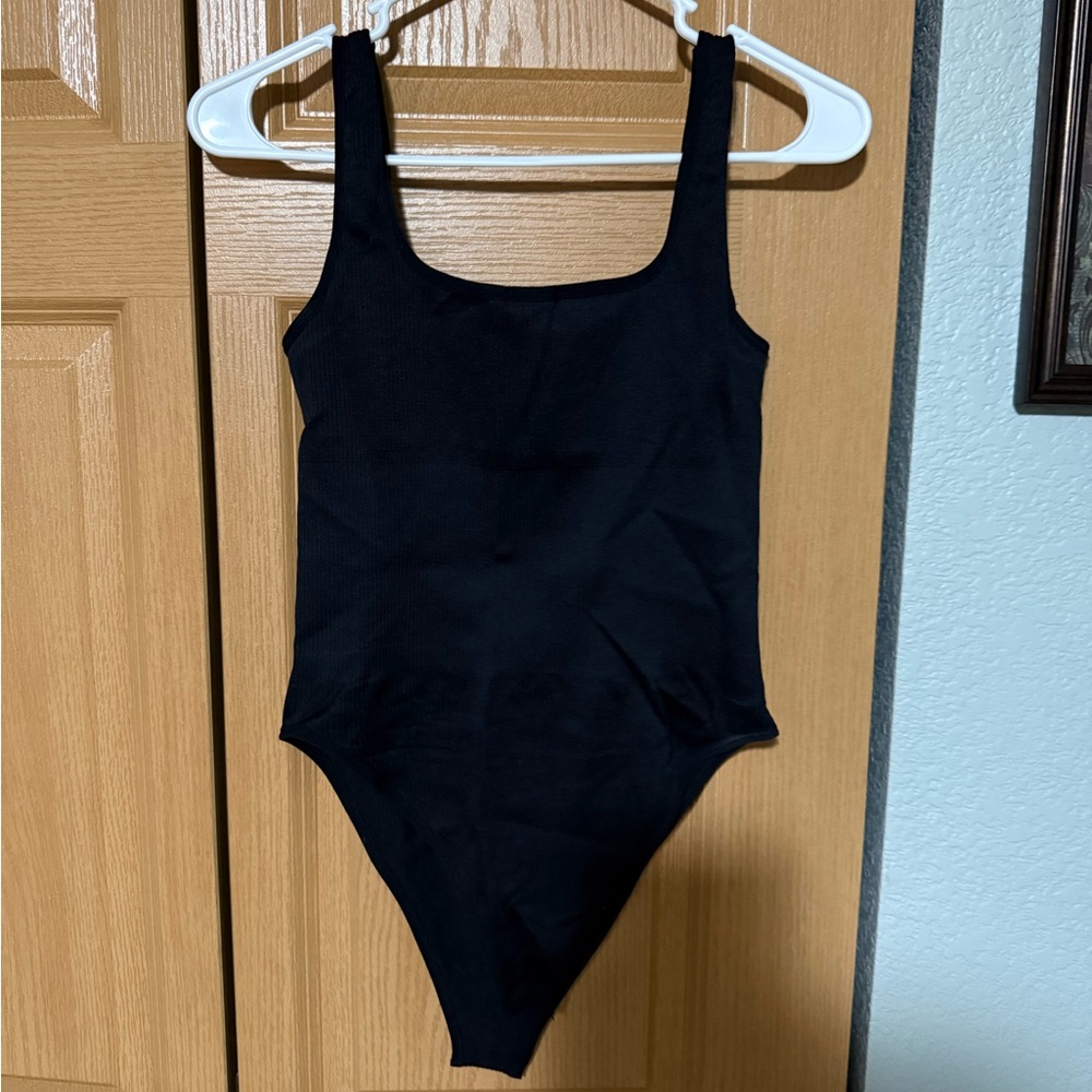 Black ribbed body suit Brand new.  No package. Size M